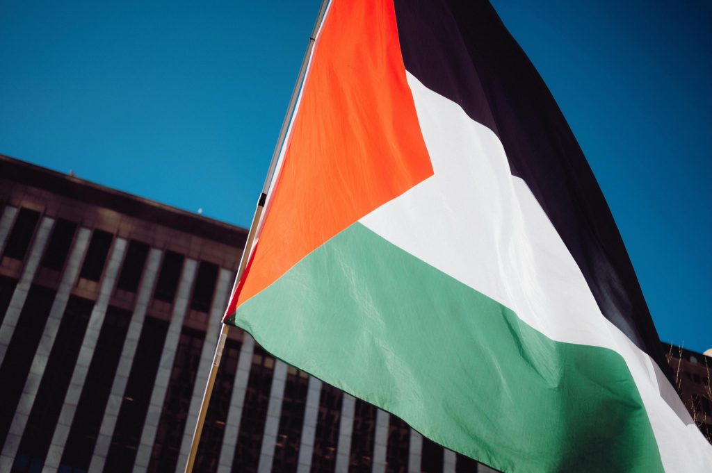 A Palestinian flag flying in front of an office building